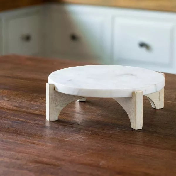 white marble cake stand with wooden base