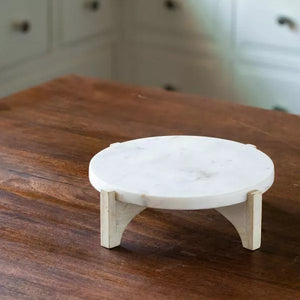 white marble cake stand with wooden base